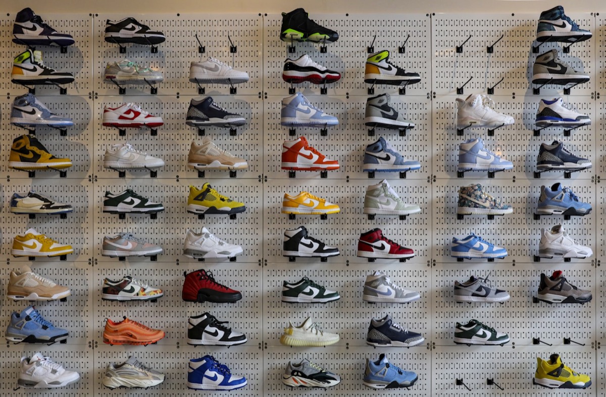 The shoe wall inside the store — rows of sneakers on white pegboard.